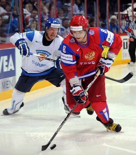 Russian Alexander Ovechkin (R) vies for the puck with Finnish Ossi Vaananen